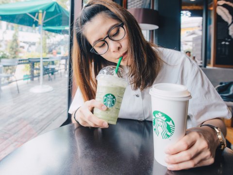 woman drinking Starbucks coffee